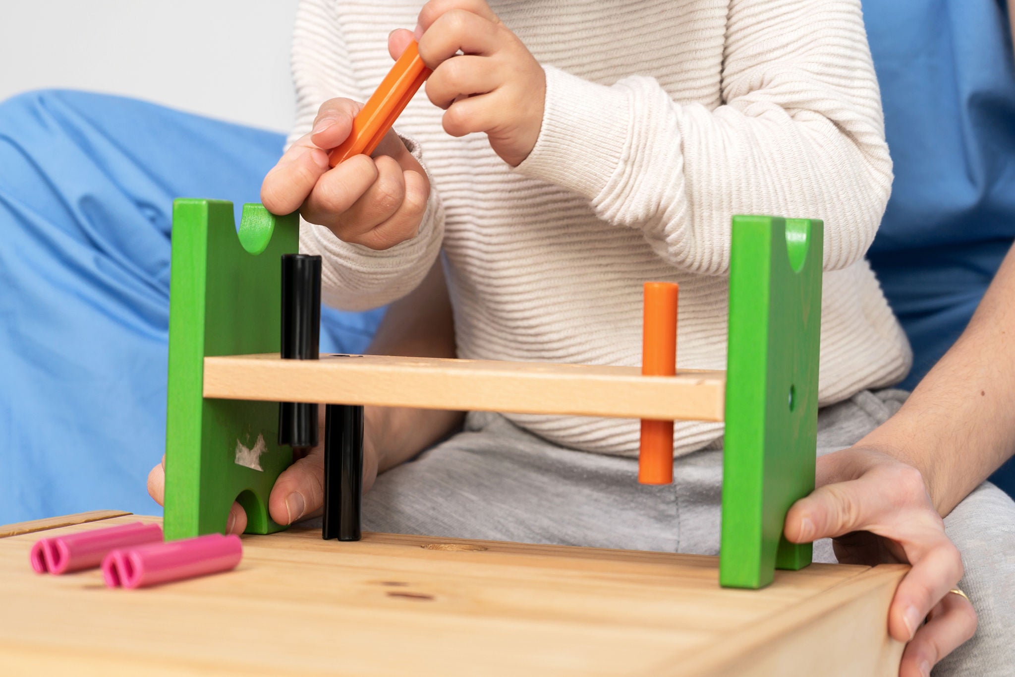 Midsection Of Man Playing With Toy On Table
